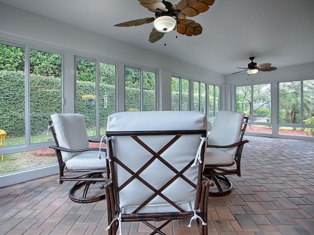 sunroom featuring ceiling fan and a healthy amount of sunlight