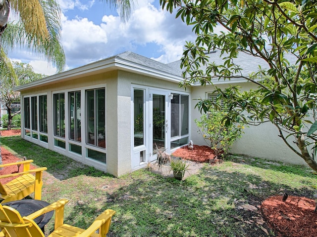 view of property exterior featuring a sunroom