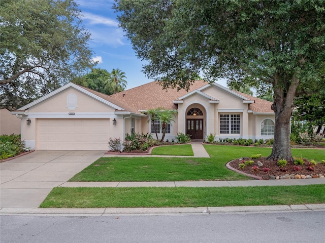 single story home with a garage and a front lawn