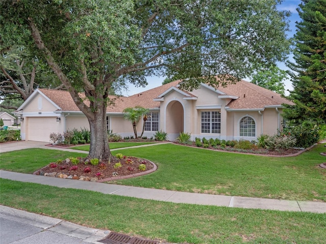 view of front facade featuring a garage and a front lawn