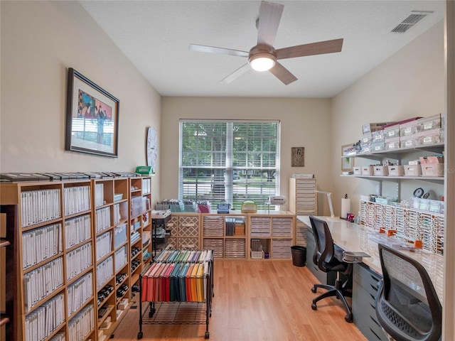 home office featuring hardwood / wood-style flooring and ceiling fan