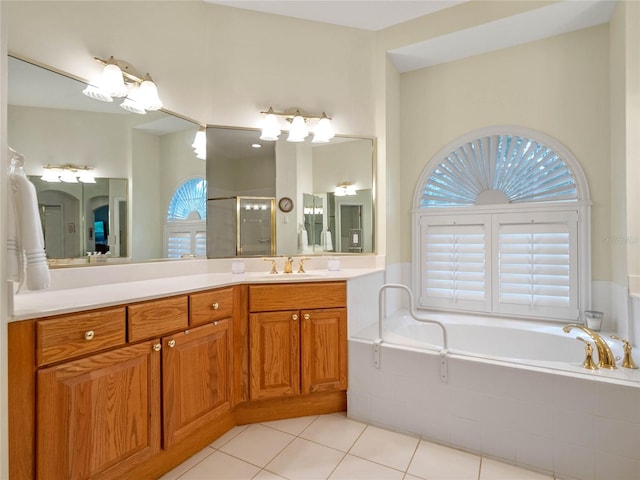 bathroom with tile patterned flooring, vanity, and plus walk in shower