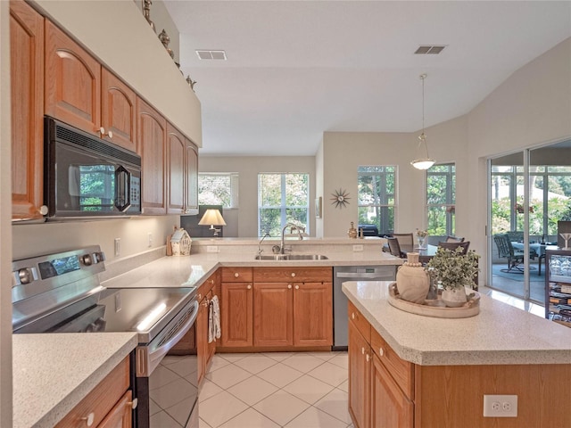 kitchen featuring sink, kitchen peninsula, decorative light fixtures, light tile patterned floors, and appliances with stainless steel finishes