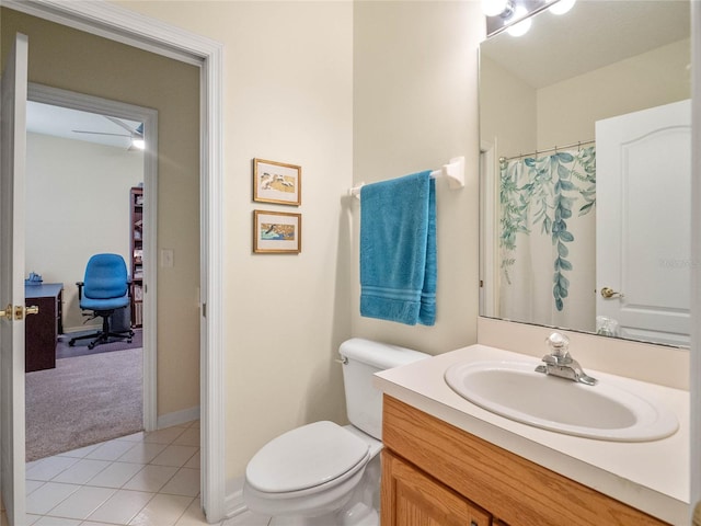 bathroom with tile patterned flooring, vanity, and toilet