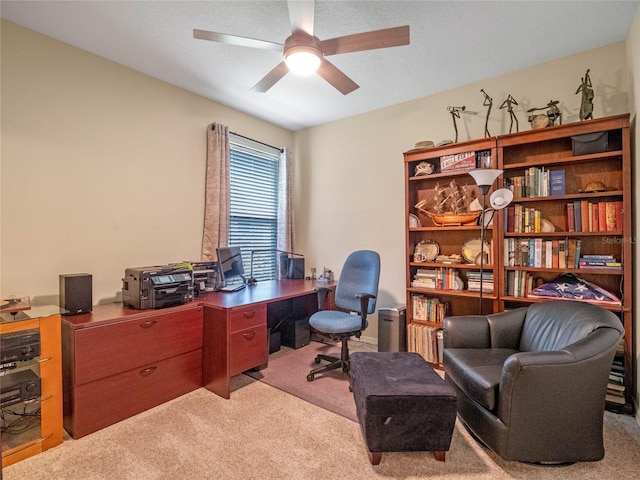 office space featuring ceiling fan and light colored carpet