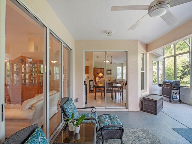 sunroom / solarium featuring ceiling fan