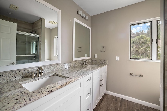 bathroom featuring vanity and an enclosed shower