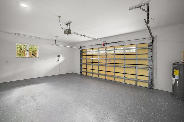 garage featuring electric water heater and a garage door opener