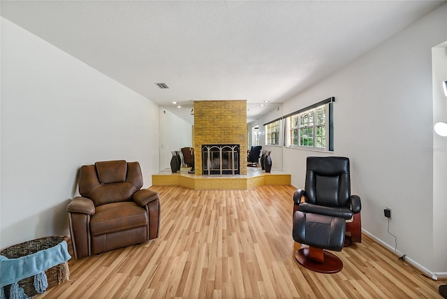 living room with hardwood / wood-style floors and a fireplace