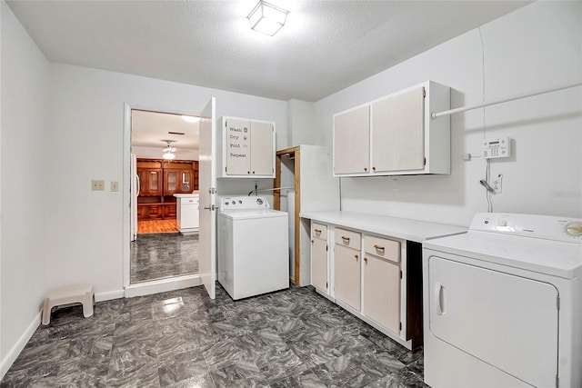 laundry room featuring cabinets, a textured ceiling, ceiling fan, and washing machine and clothes dryer