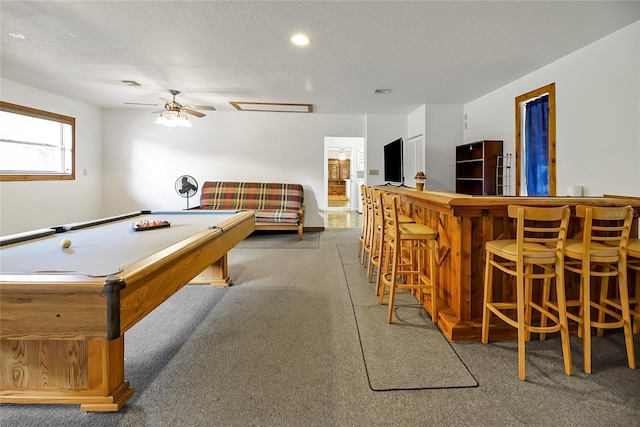 recreation room featuring carpet, a textured ceiling, ceiling fan, billiards, and bar area