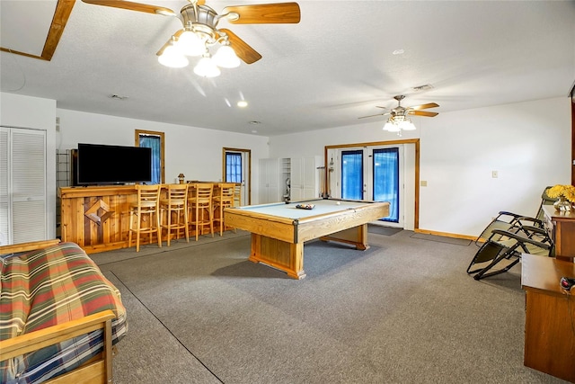 game room with carpet, bar area, a textured ceiling, and pool table