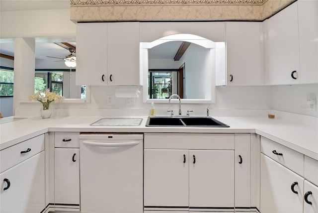 kitchen featuring white dishwasher, ceiling fan, white cabinetry, and sink