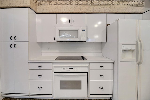 kitchen with white cabinets and white appliances