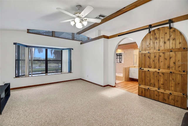 unfurnished living room featuring ceiling fan, lofted ceiling, and light carpet