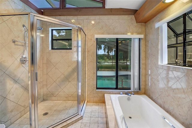 bathroom featuring separate shower and tub, tile patterned floors, and tile walls