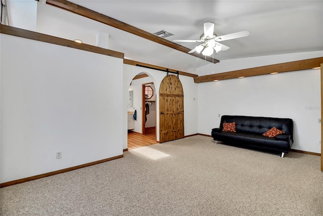 sitting room with ceiling fan, lofted ceiling, and light carpet