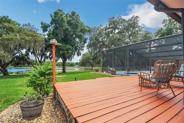 wooden deck featuring a lawn, glass enclosure, and a water view