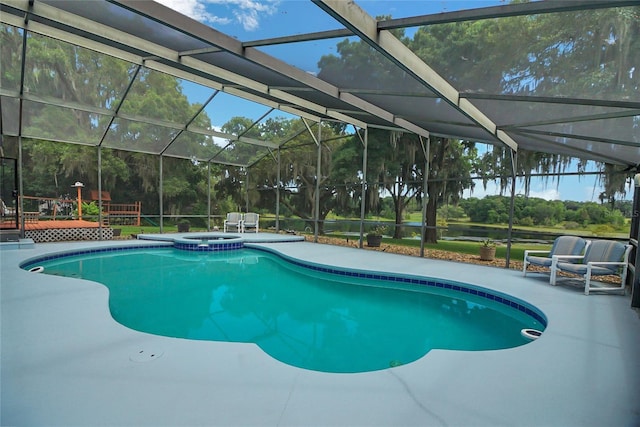 view of pool featuring glass enclosure and a patio