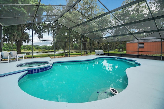 view of swimming pool featuring glass enclosure, an in ground hot tub, and a patio