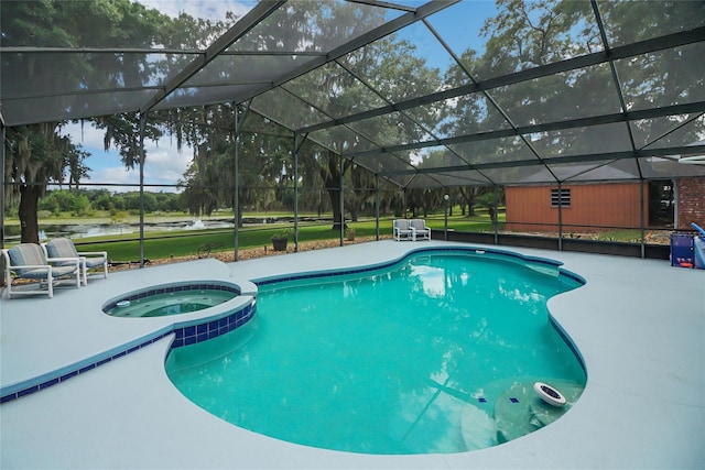 view of swimming pool featuring glass enclosure, an in ground hot tub, and a patio area