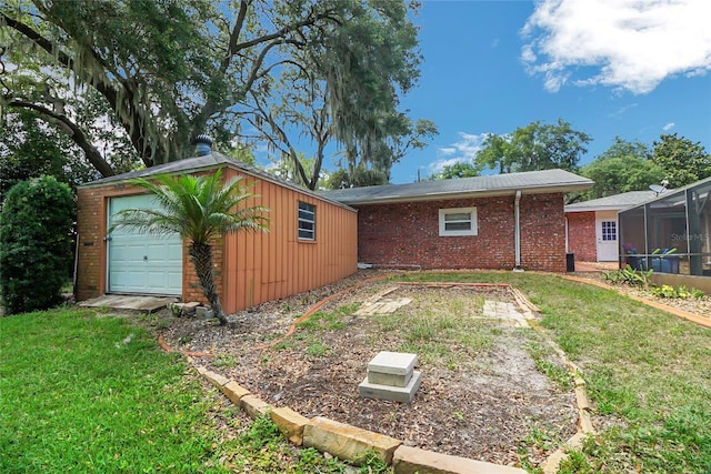 exterior space featuring an outdoor structure, a garage, and a yard