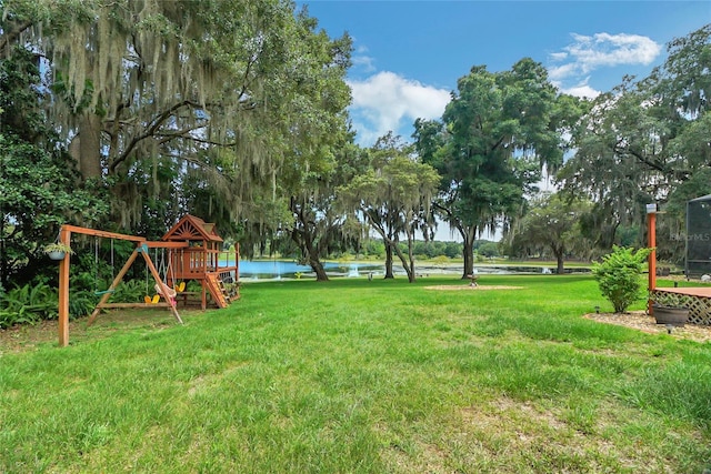 view of yard featuring a water view and a playground