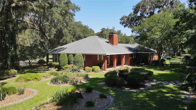 rear view of house featuring a lawn