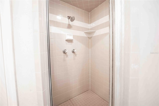 bathroom with a shower with door