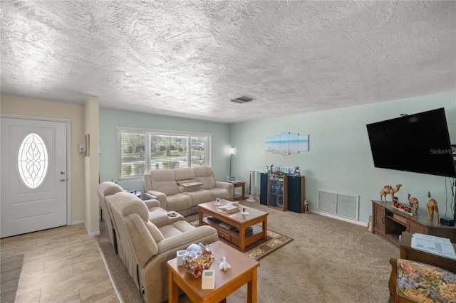 living room featuring light colored carpet and a textured ceiling