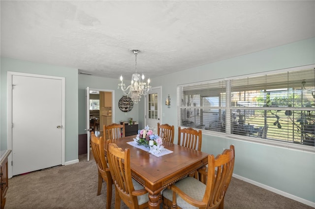 dining room featuring carpet flooring, a textured ceiling, and an inviting chandelier