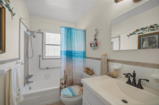 full bathroom featuring shower / tub combo, vanity, toilet, and tile walls