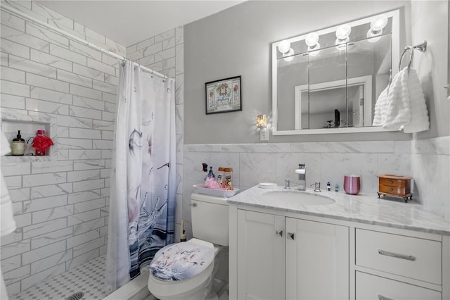 bathroom featuring toilet, vanity, tile walls, and walk in shower