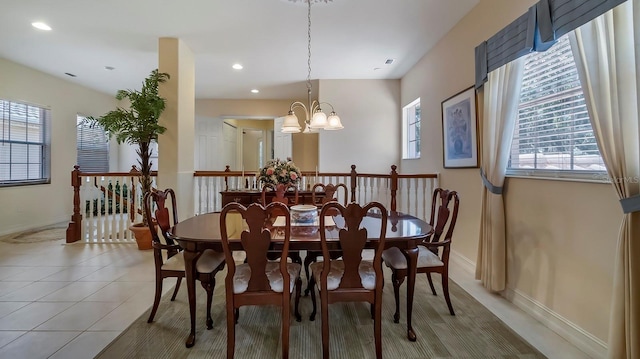 dining room featuring light tile patterned floors and an inviting chandelier