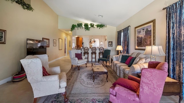 tiled living room featuring an inviting chandelier and vaulted ceiling