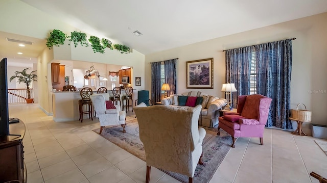 tiled living room featuring vaulted ceiling and an inviting chandelier