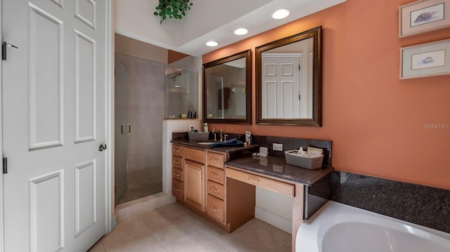 bathroom with shower with separate bathtub, vanity, and tile patterned floors