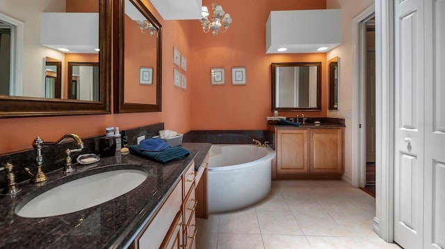 bathroom with tile patterned floors, vanity, and a bath