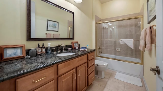 full bathroom featuring tile patterned flooring, vanity, bath / shower combo with glass door, and toilet