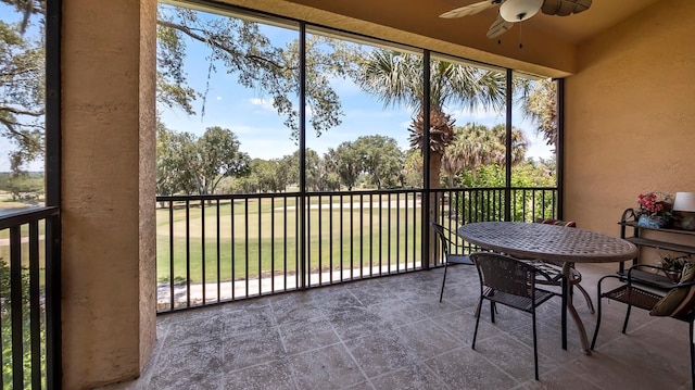 sunroom featuring ceiling fan