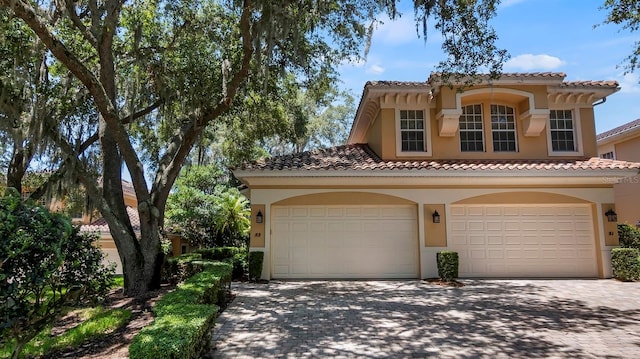 mediterranean / spanish house with a garage