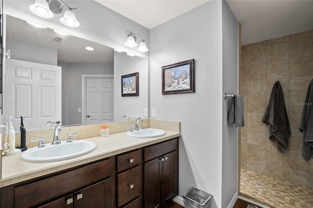 bathroom featuring vanity and a tile shower