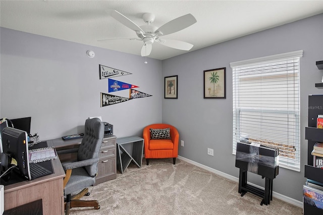 office area with ceiling fan, a healthy amount of sunlight, and light carpet