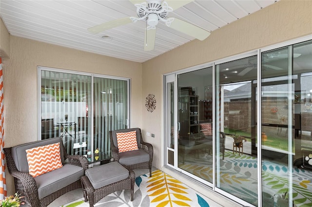 sunroom with a wealth of natural light and ceiling fan