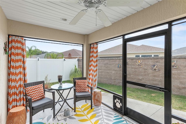 sunroom featuring ceiling fan