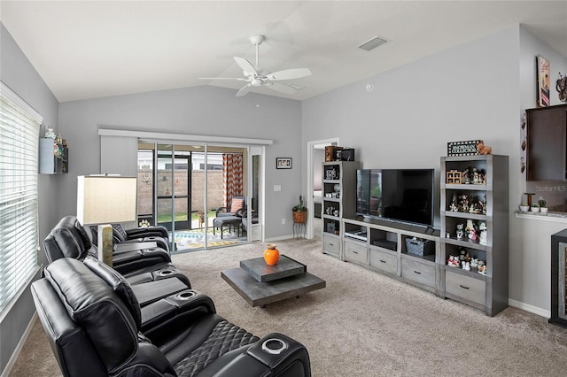 carpeted living room featuring vaulted ceiling, a wealth of natural light, and ceiling fan