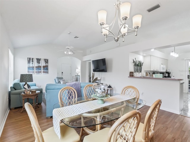 1405 W Schwartz Blvd, The Villages, FL 32159 - dining room with light wood-type flooring, a chandelier, a ceiling fan, and vaulted ceiling