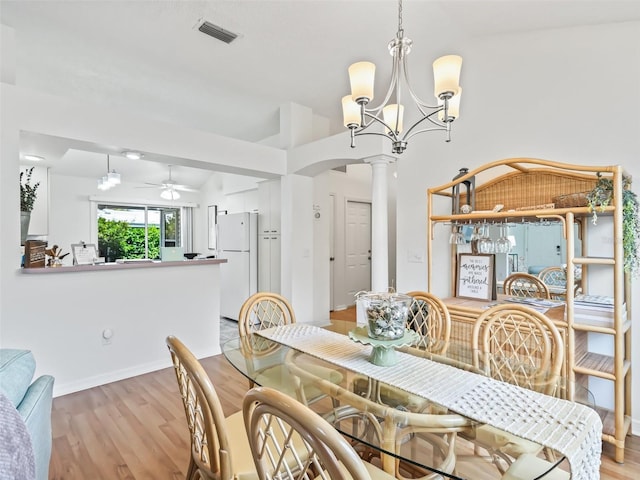 1405 W Schwartz Blvd, The Villages, FL 32159 - dining area featuring ornate columns, a ceiling fan, light wood-style floors, a chandelier, and arched walkways