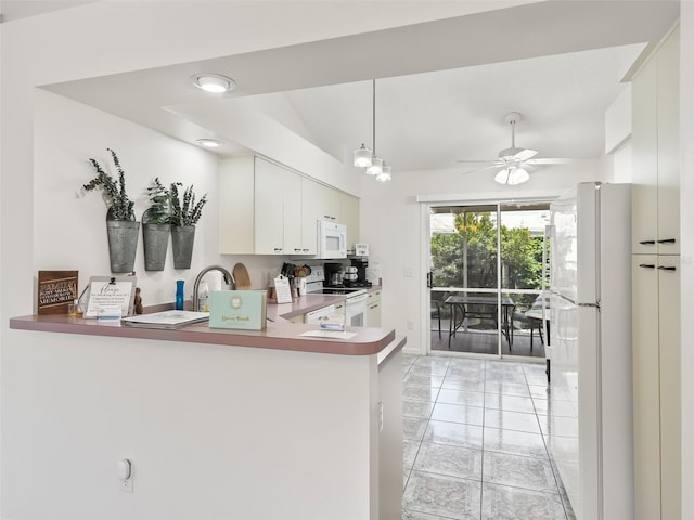 1405 W Schwartz Blvd, The Villages, FL 32159 - kitchen with white appliances, white cabinets, a ceiling fan, vaulted ceiling, and a peninsula
