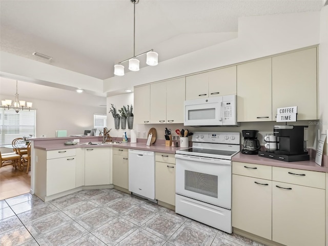 1405 W Schwartz Blvd, The Villages, FL 32159 - kitchen with white appliances, cream cabinets, plenty of natural light, and a chandelier